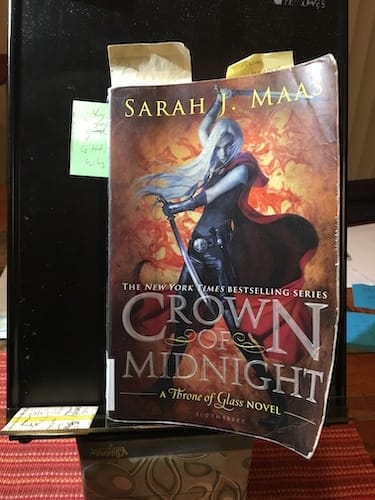 Document holder with book Photo of Crown of Midnight by Sarah J. Maas on a black document holder book stand