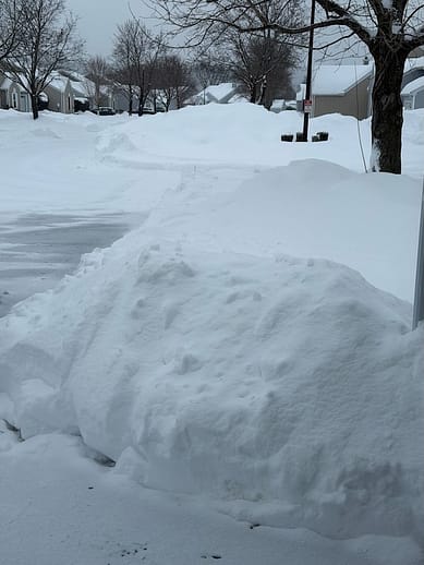 Snowy Street Banks of snow along a driveway on a residential street