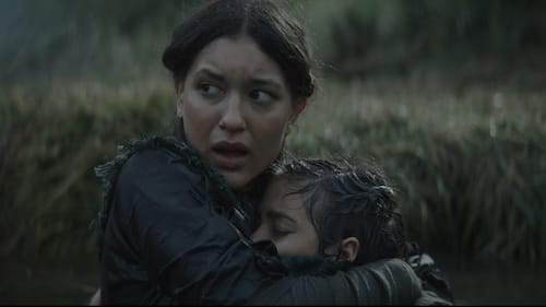 Omera A close up shot of a woman clutching her daughter to her as they stand in a pond after their village was attacked.