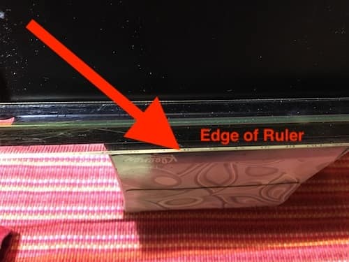 Document holder with ruler2 Photo of black document holder with a clear ruler along its edge, sitting on a box of tissues.