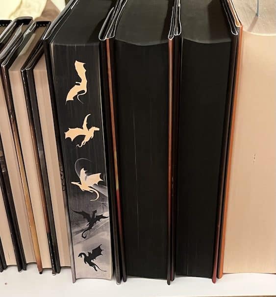 Onyx Back Photo of the page edges of Onyx Storm - a black background with tan dragon silhouettes in flight.