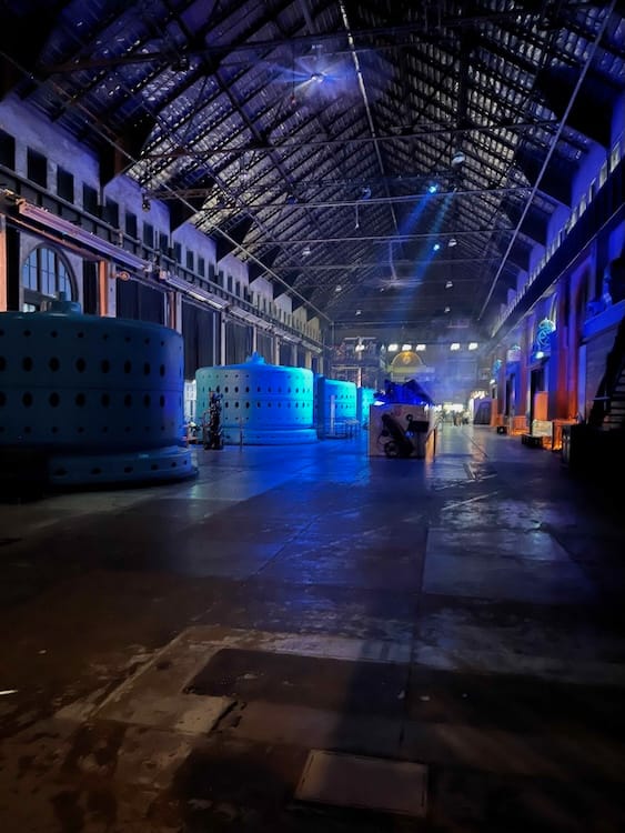 Power Station at Night Photo of the inside of the Niagara Parks Power Station at night. The lighting is dim except where blue lights illuminate the circular blue generators that are lined up on the left.
