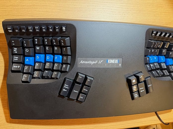 Advantage2 A one-piece ergonomic keyboard with contoured wells for the usual keys and two thumb clusters below and toward the center.